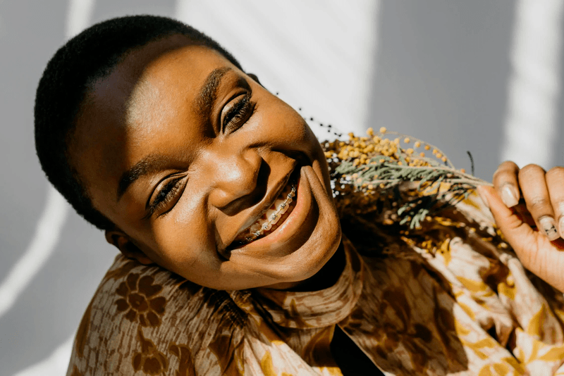 woman smiling with braces showing her braces transformation